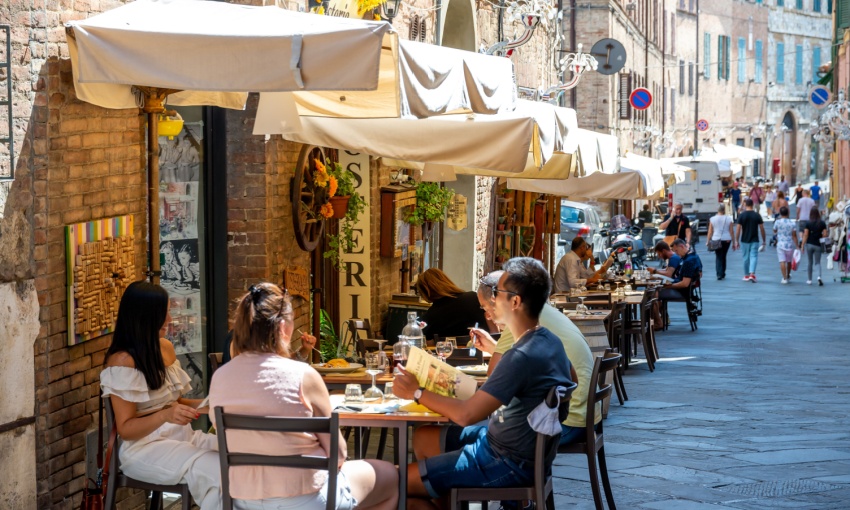 Via di un borgo italiano con tavolini 