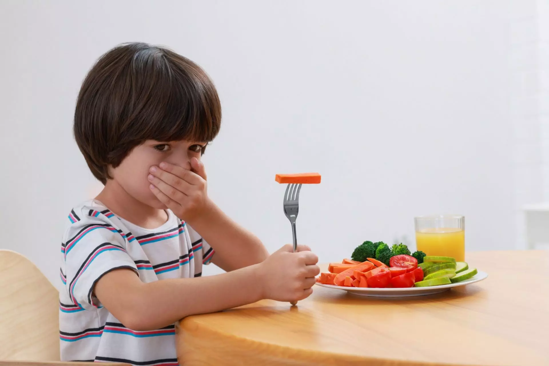 Bimbo che prova disgusto nel mangiare le verdure